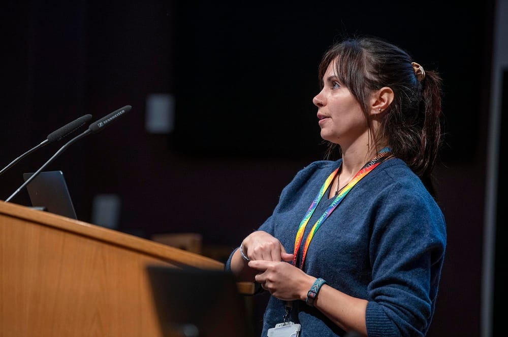 Speaker Raven Hickson presenting at the lectern