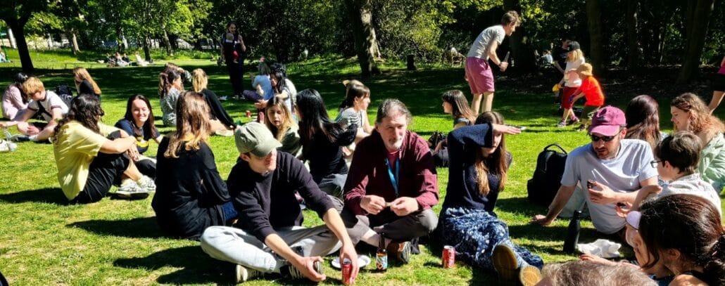 Visitors enjoying refreshments and conversations in the garden